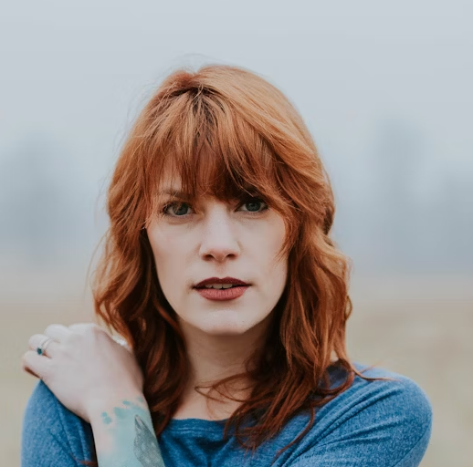 Woman with red hair in denim jacket